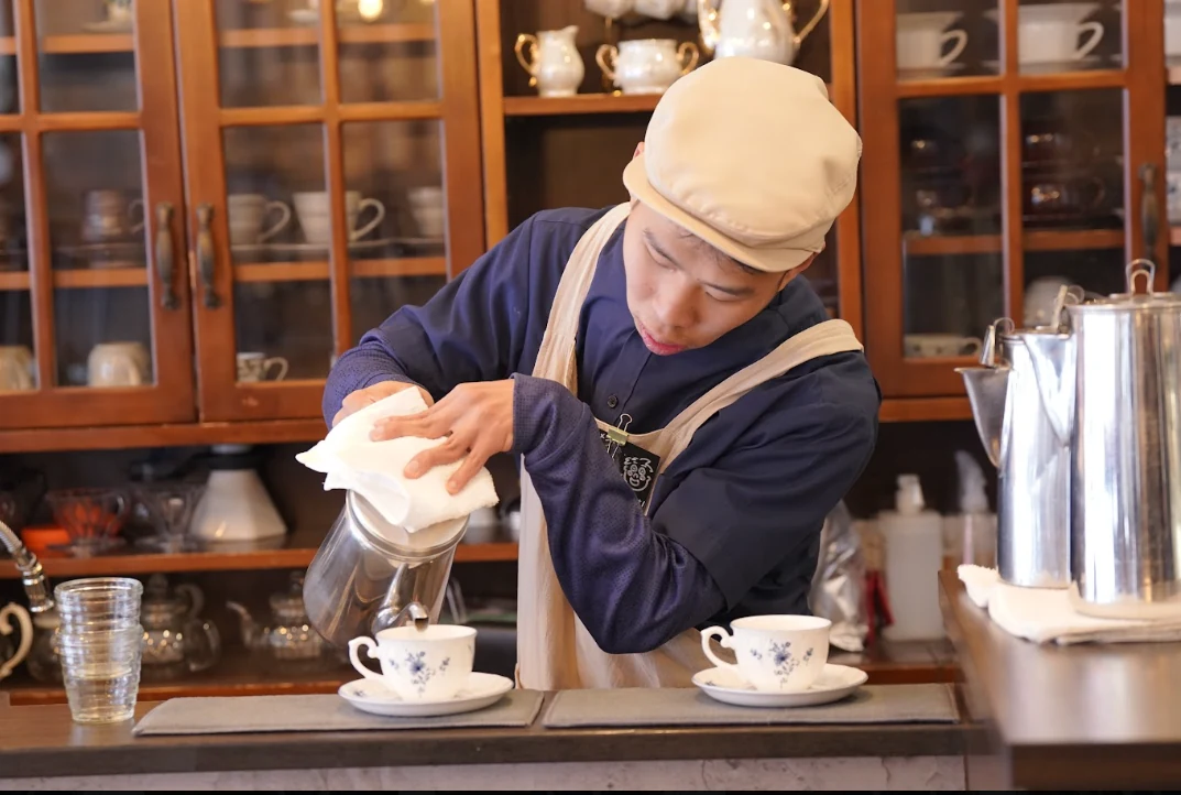コーヒーを提供するスタッフ